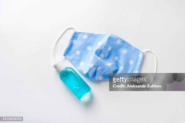 hand sanitizer and protective reusable medical stitched face mask. prevention of the spread of covid-19 coronavirus, precautions against viruses, infections, diseases. prevention of smallpox monkeys, pandemics. the concept of healthcare and medicine. - smallpox epidemic stock pictures, royalty-free photos & images