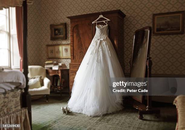wedding dress in hotel room - brautkleid stock-fotos und bilder