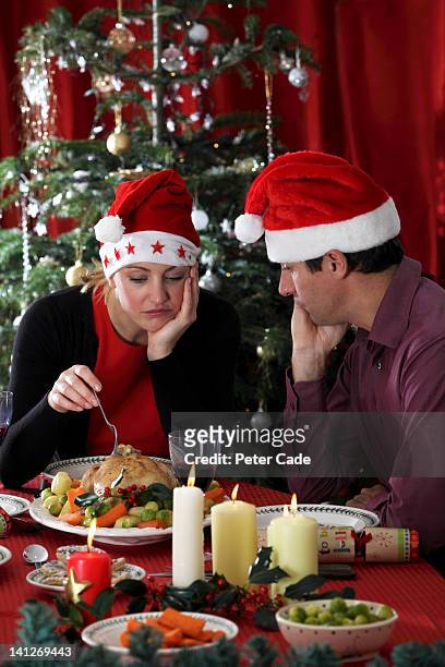 miserable couple having christmas dinner - christmas angry stock pictures, royalty-free photos & images