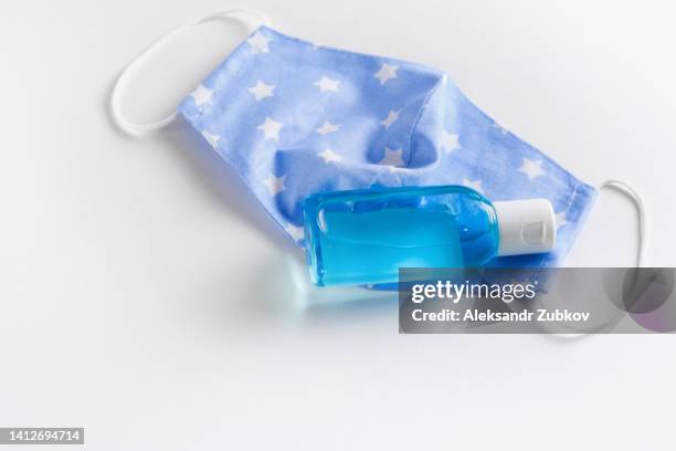 hand sanitizer and protective reusable medical stitched face mask. prevention of the spread of covid-19 coronavirus, precautions against viruses, infections, diseases. prevention of smallpox monkeys, pandemics. the concept of healthcare and medicine. - smallpox epidemic stock pictures, royalty-free photos & images