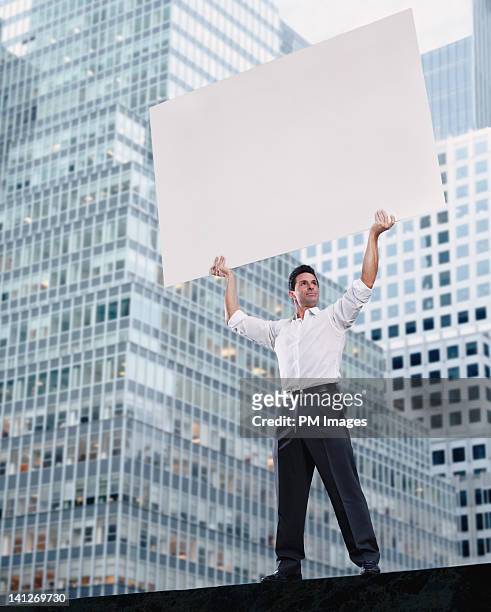 businessman holding blank sign - placard stock pictures, royalty-free photos & images
