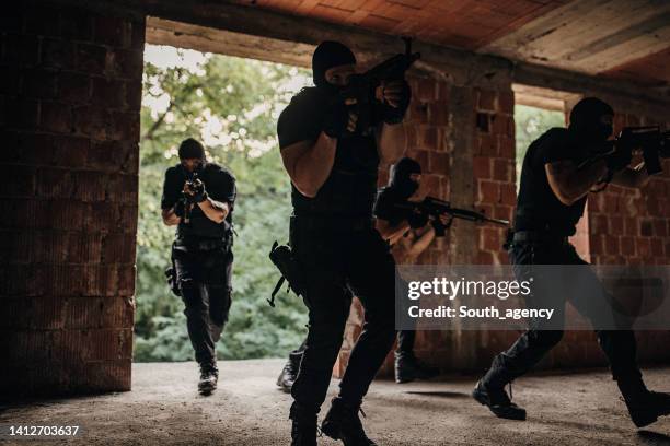 swat team in action - police entering stock pictures, royalty-free photos & images
