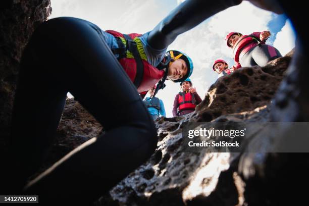 climbing down into the caves - caving stock pictures, royalty-free photos & images