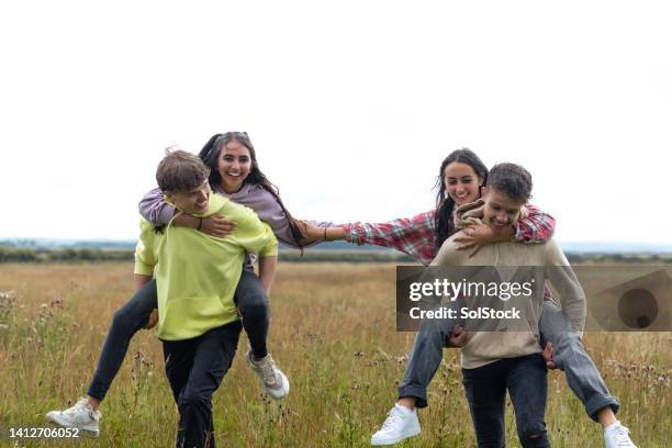 piggy backing racing - teenagers only stock pictures, royalty-free photos & images