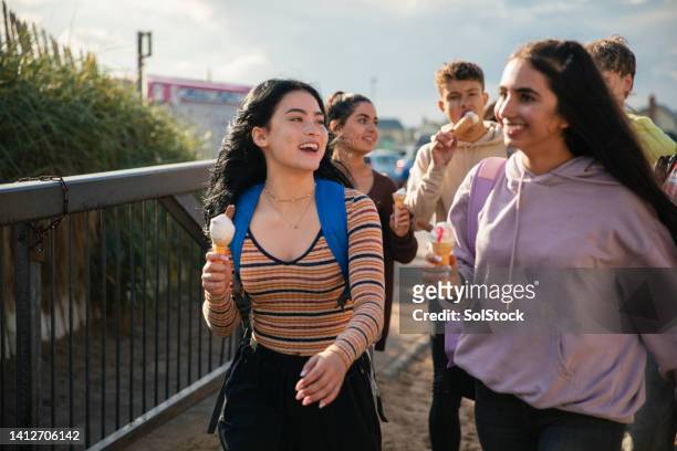 friends eating a sweet treat - teenagers only stock pictures, royalty-free photos & images