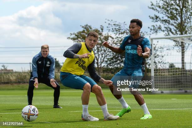 Jacob Murphy passes the ball as Kieran Trippier defends as Newcastle United Head Coach Eddie Howe looks on during the Newcastle United Training...