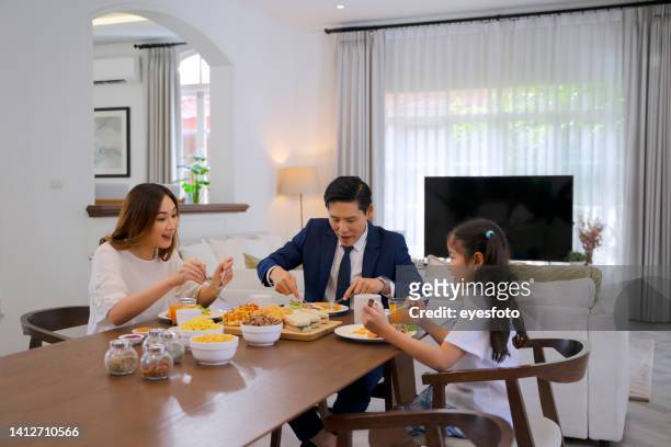 family have breakfast at home before go to work. - wealthy family inside home stock pictures, royalty-free photos & images