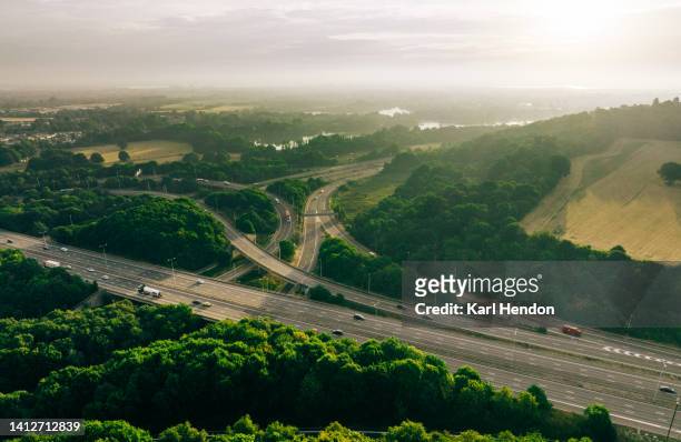 an aerial sunrise view of a multi-lane road  intersection - motorway uk stock pictures, royalty-free photos & images
