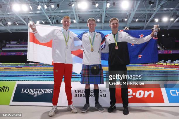 Silver medalist, Tom Dean of Team England, Gold medalist, Duncan Scott of Team Scotland and Bronze medalist, Lewis Clareburt of Team New Zealand pose...