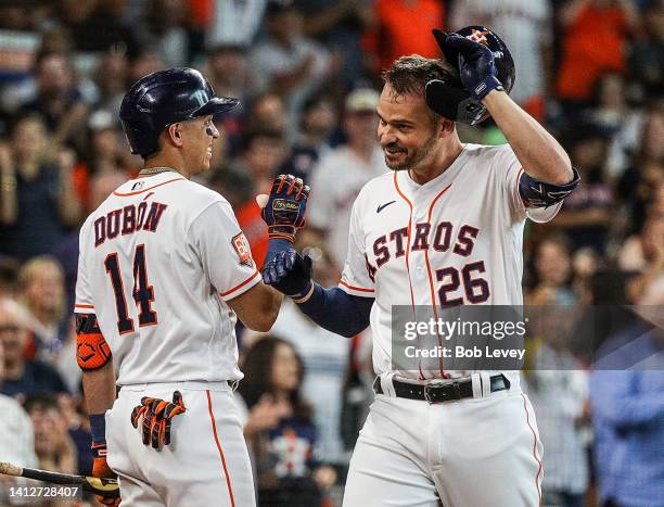 Trey Mancini of the Houston Astros receives high five from Mauricio Dubon after hitting a two run home run in the second inning against the Boston...