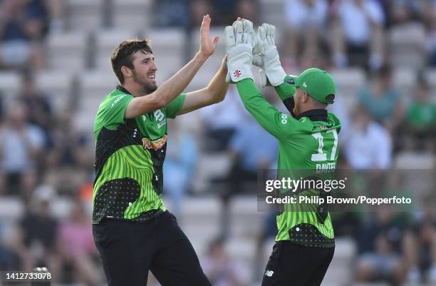 Craig Overton of Southern Brave is congratulated by Alex Davies after dismissing Joe Clarke of Welsh Fire during The Hundred match between Southern...