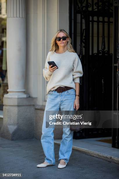 Claire Rose Cliteur is seen wearing shoes Aeyde, denim jeans Levis, knit Claes, belt, Fendi bag on August 03, 2022 in Barcelona, Spain.