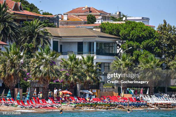 People flock to a beach to cool off during a hot sunny day in Kinaliada, one of the Princes' Islands, in Istanbul, Turkey, on Monday, August 1, 2022....