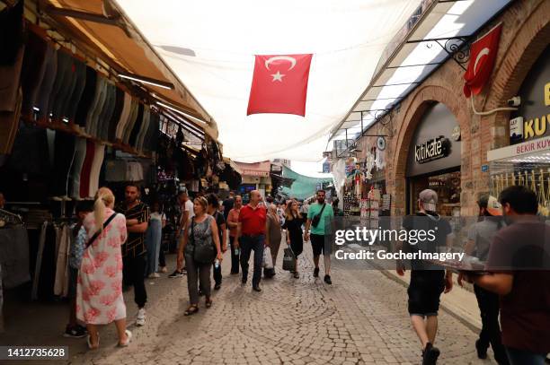 Shoppers walk along a bazaar in Izmir, Turkey, on Wednesday, August 3, 2022. Turkey's annual inflation soared to 79.6 percent in July, the Turkish...