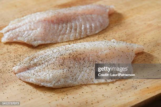 preparing parmesan crusted tilapia - halibut fillet raw stock pictures, royalty-free photos & images
