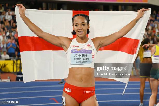 Gold medal winner Katarina Johnson-Thompson of Team England celebrates with their teams flag after winning the Women's Heptathlon on day six of the...