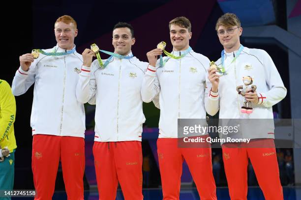 Gold medalists, Tom Dean, Brodie Paul Williams, James Wilby and James Guy of Team England pose with their medals during the medal ceremony for the...