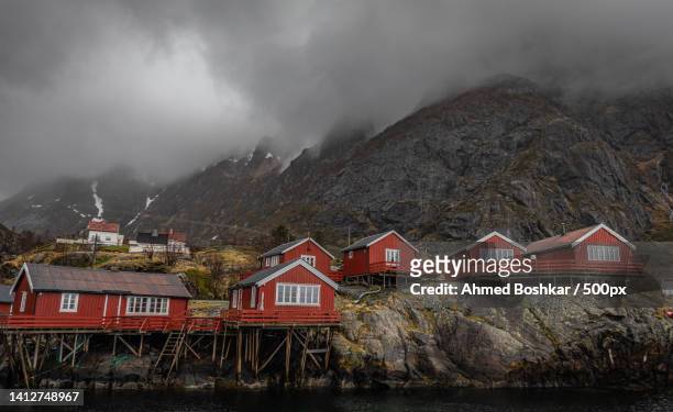 scenic view of lake by buildings against sky - fishing village stock pictures, royalty-free photos & images