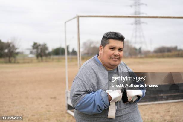portrait of mentally disabled happy young soccer player at field - mental disability stock pictures, royalty-free photos & images