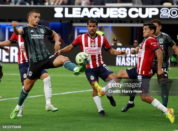 Dejan Joveljic of Los Angeles Galaxy scores in front of Jesus Sanchez of Guadalajara Chivas, to take a 1-0 lead, during the first half of the Leagues...