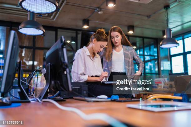 build effective team collaboration in financial tech business company. a female software developer decision on design time line and progress for custom software in a tech business office - software as a service stock pictures, royalty-free photos & images