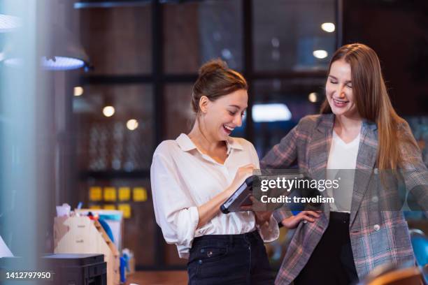 build effective team collaboration in financial tech business company. a female software developer decision on design time line and progress for custom software in a tech business office - software as a service stock pictures, royalty-free photos & images