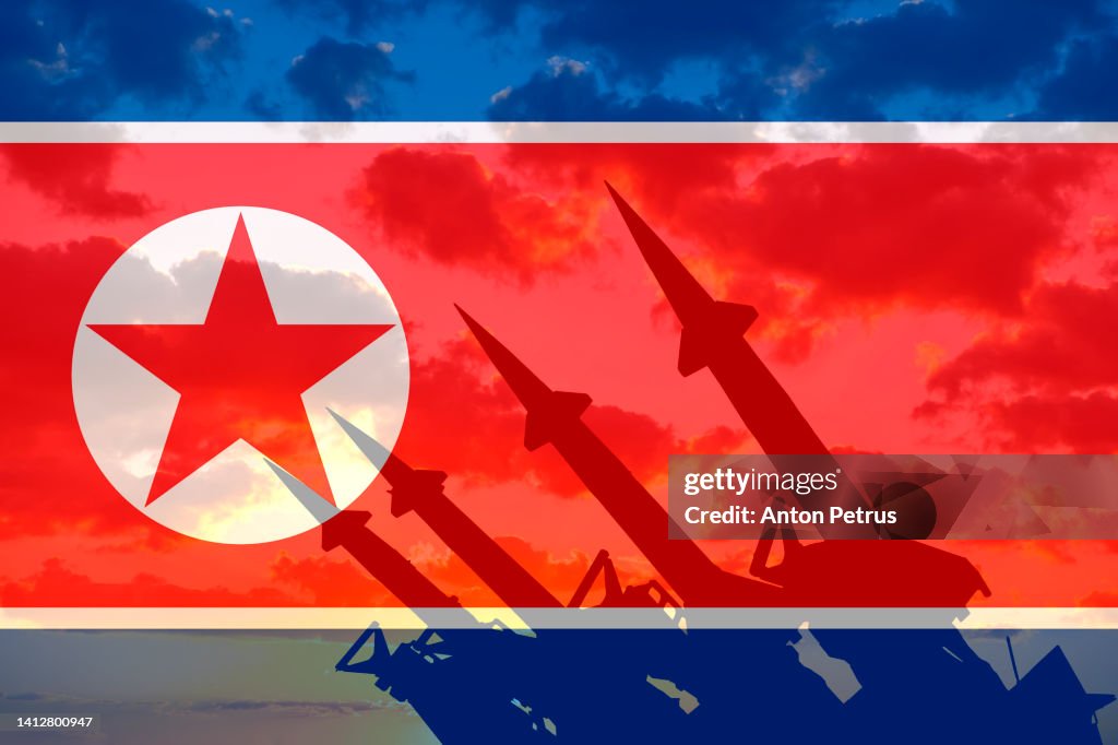 Nuclear weapon on the background of the North Korean flag