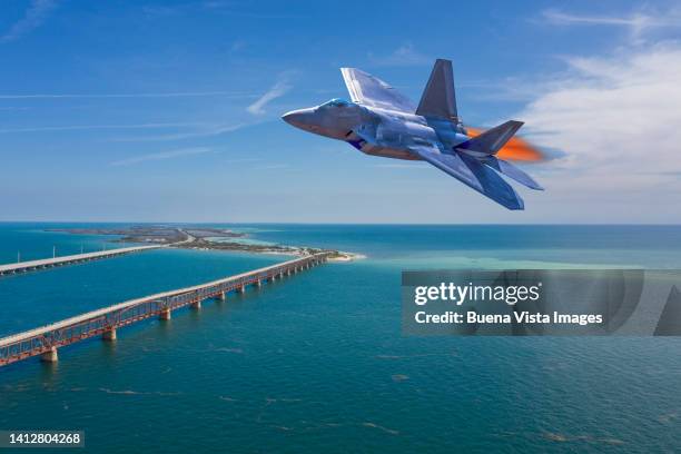 army jet fighter flying over the florida keys - contact list stock-fotos und bilder