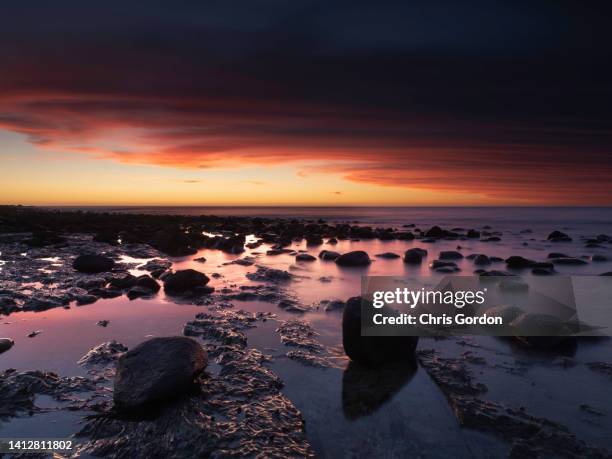 dramatic long exposure beach sunset - dramatic landscape stock pictures, royalty-free photos & images