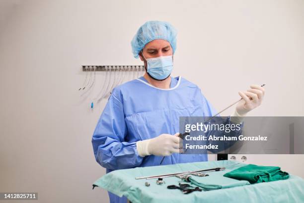surgeon preparing and setting up tools for a laparoscopic surgery - laparoscopic surgery ストックフォトと画像