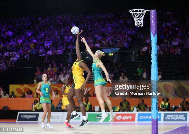 Jhaniele Karyl Fowler of Jamaica competes for the ball with Courtney Bruce of Australia during the Group A Netball match between Australia and...