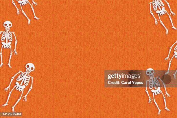 halloween background skeletons and spiders in orange - scary pumpkin faces bildbanksfoton och bilder