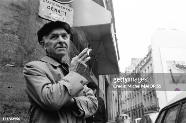 French photographer Robert Doisneau in the Odeon neighborhood with one of his picture on a wall behind him, on May 31, 1988 in Paris, France.