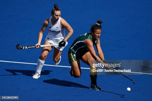 Jean-Leigh du Toit of Team South Africa competes with Anna Crowley of Team New Zealand during Women's Hockey - Pool B match South Africa and New...