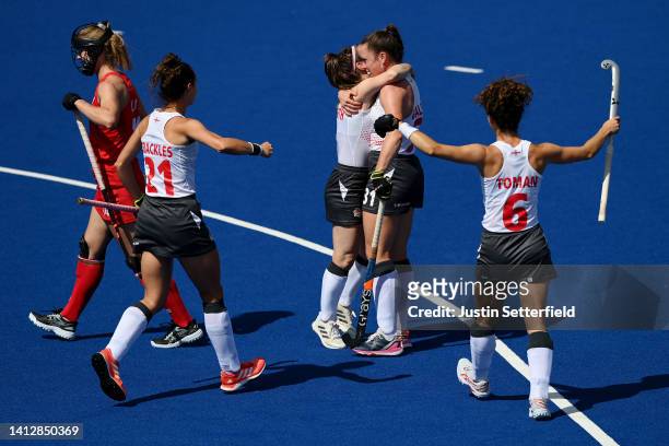 Grace Balsdon of Team England celebrates with team mates after scoring their sides third goal during Women's Hockey - Pool A match between England...
