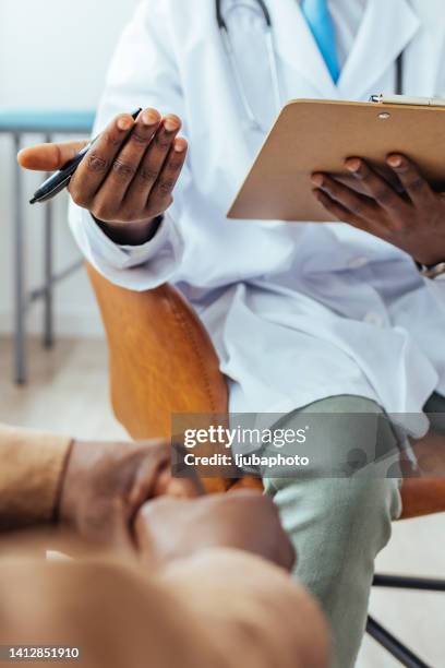 close up of doctor writing on a medical chart. - medical chart stock pictures, royalty-free photos & images