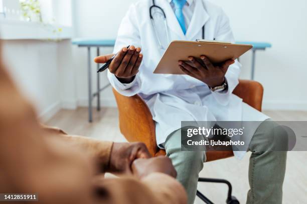 man with cancer talking to doctor - gp visit stock pictures, royalty-free photos & images