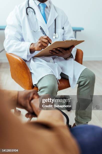 male doctor filling patient history list - patient history stock pictures, royalty-free photos & images