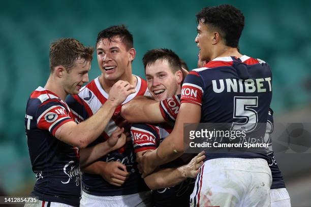 Luke Keary of the Roosters celebrates with team mates after scoring a try during the round 21 NRL match between the Sydney Roosters and the Brisbane...
