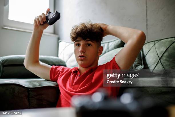 a teenage boy is having a hard time winning in a video game. - work hard play hard stock pictures, royalty-free photos & images