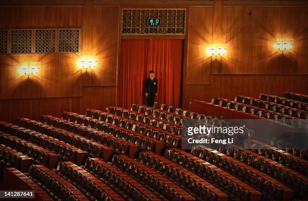 Security officer guards at the entrance of the meeting hall before the closing session of the National Peoples Congress at The Great Hall Of The...