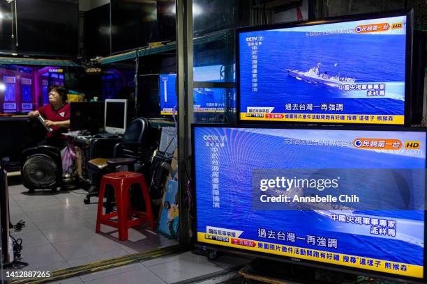 Television shows a news broadcast about China Conducting a live file drill around Taiwan at a local electrical repair store after Speaker of the...