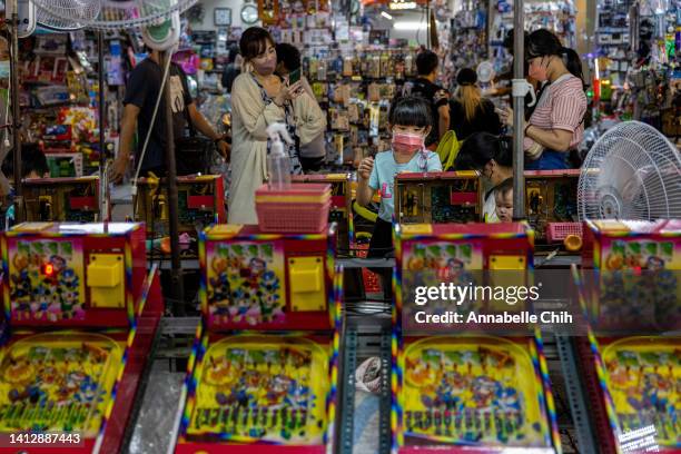 Child plays pinball at a local night market on August 04, 2022 in Taipei, Taiwan. Taiwan remained tense after Speaker of the U.S. House Of...