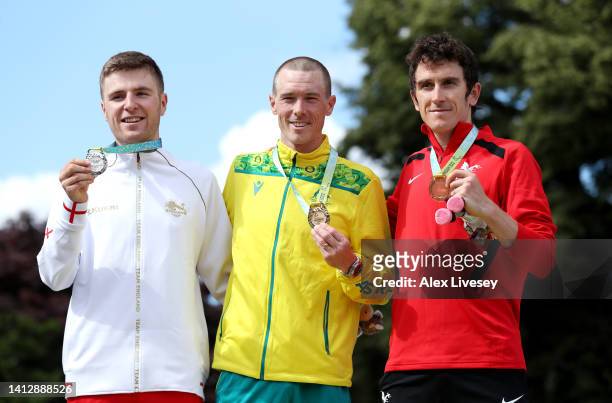 Silver Medalist, Fred Wright of Team England, Gold Medalist, Rohan Dennis of Team Australia and Bronze Medalist, Geraint Thomas of Team Wales pose...