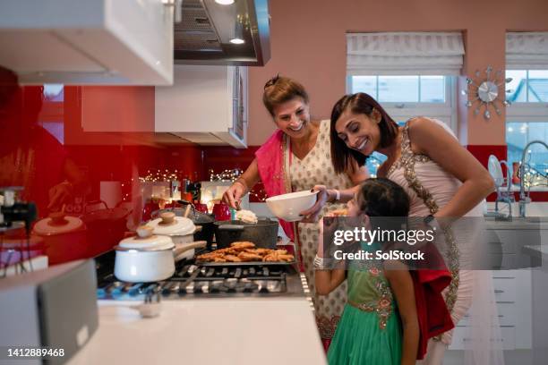 three generations cooking together - diwali family stock pictures, royalty-free photos & images