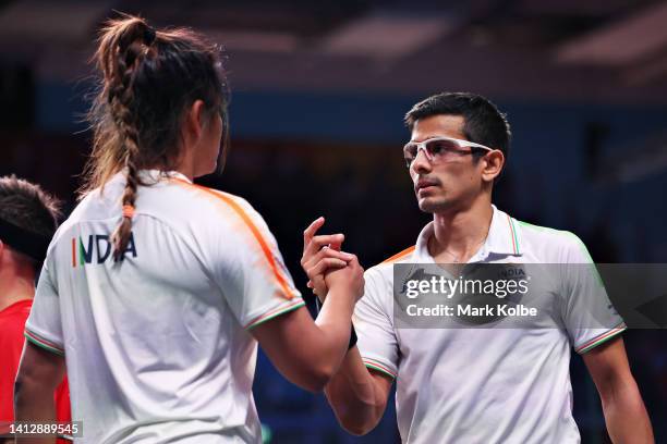 Saurav Ghosal and Dipika Pallikal Karthik of Team India shake hands after winning during their Squash Mixed Doubles Round of 16 match against Emily...