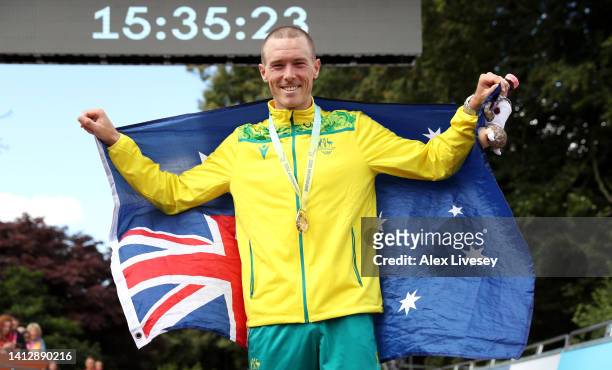 Gold Medalist, Rohan Dennis of Team Australia celebrates with their flag during the Men's Individual Time Trial medal ceremony on day seven of the...