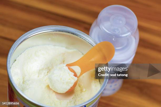 preparation of mixture baby feeding on wooden background top vie - vie simple stock-fotos und bilder