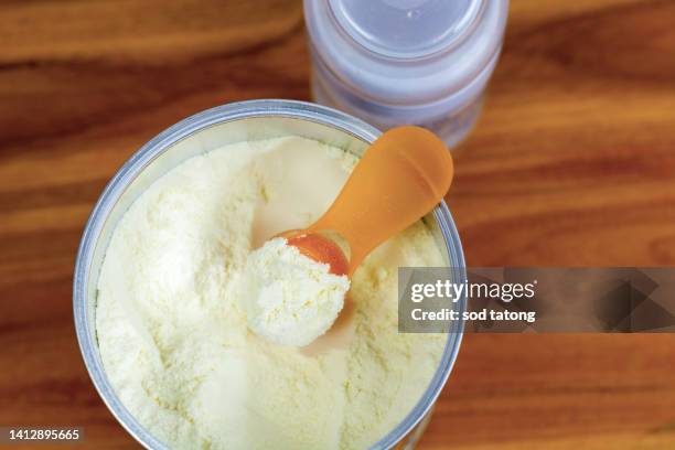 preparation of mixture baby feeding on wooden background top vie - milchpulver stock-fotos und bilder