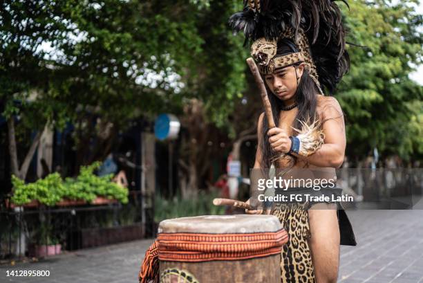 intérprete azteca tocando el tambor al aire libre - azteca fotografías e imágenes de stock